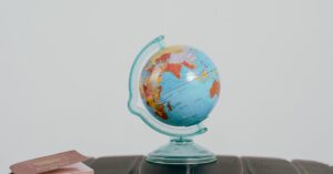 A globe and passport on a suitcase, symbolizing travel planning and wanderlust.